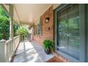 Inviting front porch with brick facade and decorative lighting fixture at 2578 Morgan Lake Ne Dr, Marietta, GA 30066