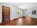 Bright living room with hardwood floors and a stylish wooden front door at 2578 Morgan Lake Ne Dr, Marietta, GA 30066