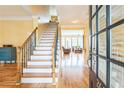 Bright foyer showcasing hardwood floors, staircase, and an open view to the living area at 266 Monarch Village Way, Stockbridge, GA 30281