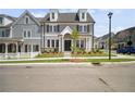 Charming two-story home featuring gray siding, a landscaped yard, and a welcoming front porch at 202 Dawson Dr, Woodstock, GA 30188