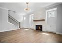 Bright living room with hardwood floors, a modern fireplace, and a staircase at 202 Dawson Dr, Woodstock, GA 30188