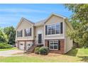 Charming two-story home with neutral siding, black shutters, brick accents and an inviting front entrance at 2175 Golden Valley Dr, Lawrenceville, GA 30043