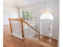 Inviting foyer with wood floors, staircase and arched entryway with a transom window and stylish pendant lighting at 2175 Golden Valley Dr, Lawrenceville, GA 30043