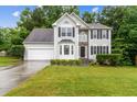 Charming two-story home with stone accents, well-manicured lawn, and a two-car garage at 570 White Stag Ct, Suwanee, GA 30024