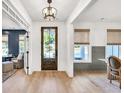 Inviting foyer with hardwood floors, stylish lighting, and a view into the adjacent living spaces at 401 Pirkle Ave, Buford, GA 30518