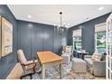 Comfortable home office with dark blue walls, natural light, and seating areas for work or relaxation at 401 Pirkle Ave, Buford, GA 30518
