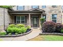 Welcoming covered entrance with detailed brickwork and professional landscaping at 2040 Bloomfield Ct, Cumming, GA 30041