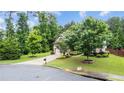 Well-manicured front yard with mature trees and landscaping adds curb appeal at 2040 Bloomfield Ct, Cumming, GA 30041
