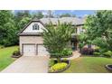 Charming two-story home with a manicured lawn and a two car garage at 2040 Bloomfield Ct, Cumming, GA 30041