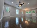 This bright living area has gleaming hardwood floors, large windows, and easy access to outdoor living spaces at 766 Longleaf Dr, Forest Park, GA 30297