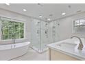 Modern bathroom featuring a glass-enclosed shower, a soaking tub, and updated fixtures at 963 Bolingbrook Sw Dr, Marietta, GA 30064