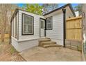 The rear of the house, showcasing a patio and a series of steps to the home's entrance at 484 Lorene Sw Dr, Marietta, GA 30060