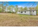 View of the home's backyard with detached garage and landscaping, including an area for gardening at 484 Lorene Sw Dr, Marietta, GA 30060