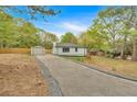 View of the property showcasing the backyard, detached garage, and long driveway at 484 Lorene Sw Dr, Marietta, GA 30060
