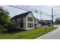 Two-story home featuring an external stairway, a covered porch, and boarded up windows for added protection and safety at 700 W College St, Bowdon, GA 30108