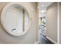 Hallway with round mirror leading to a bright living space at 2626 Peachtree Nw Rd # 1108, Atlanta, GA 30305
