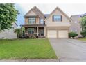 Charming two-story home with a combination of stone and siding, complemented by a well-kept green lawn at 3758 Lake Haven Way, Atlanta, GA 30349