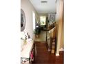 Inviting home entryway with hardwood floors and a view into the living area with a fireplace at 5230 Centennial Hill Nw Dr, Acworth, GA 30102