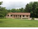 Charming single-story brick home with arched entries and a well-manicured lawn at 5513 N Richland Creek Rd, Buford, GA 30518