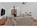 Cozy living room features a brick fireplace, hardwood floors, and neutral color scheme at 597 Rich Davis Rd, Hiram, GA 30141