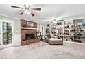 Comfortable living room with brick fireplace, built-in shelving, and sun-filled windows at 6360 Lakeview Ter, Douglasville, GA 30135