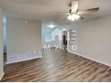 Inviting living space with a ceiling fan, built-in shelving, and wood-look flooring at 7054 Chappell Cir, Atlanta, GA 30360