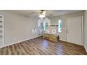 Bright living room featuring stylish flooring, a ceiling fan, and ample natural light at 7054 Chappell Cir, Atlanta, GA 30360