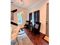 Cozy dining area with modern chandelier, dark chairs, and black and white decor accents at 1463 Macklone Ne St, Atlanta, GA 30307