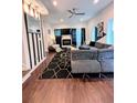 Bright living room with a gray sectional, fireplace, and striking black and white striped accent wall at 1463 Macklone Ne St, Atlanta, GA 30307