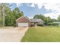 Charming single Gathering home with a beautiful front yard and a brick facade at 1623 Pratt Rd, Covington, GA 30014