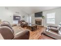 Living room with a fireplace, vaulted ceiling and leather seating at 1623 Pratt Rd, Covington, GA 30014
