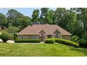 Charming single-story home boasting a well-manicured lawn and inviting stone accents at 115 Windover Ct, Roswell, GA 30075