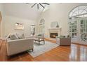 Inviting living room with fireplace, hardwood floors, neutral paint and french doors at 115 Windover Ct, Roswell, GA 30075