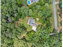 An aerial view of a well-maintained property with a lush landscape, surrounded by mature trees at 25 Highlands Way, Oxford, GA 30054