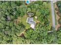 An aerial view of a property address in a lush landscape with mature trees, set on 2.89 acres at 25 Highlands Way, Oxford, GA 30054