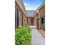 A welcoming entrance showcases a brick walkway and lush green landscaping, guiding you to the front door at 25 Highlands Way, Oxford, GA 30054