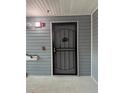 Apartment entrance with a metal security door and gray siding at 3204 Fairington Village Dr, Lithonia, GA 30038