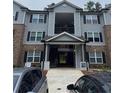 Close-up of the apartment building's entrance with gray siding and a covered walkway at 3204 Fairington Village Dr, Lithonia, GA 30038