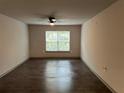 Bright living room with hardwood floors, a ceiling fan, and a large window at 3204 Fairington Village Dr, Lithonia, GA 30038