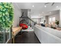 Bright, open-concept living room with dark hardwood floors, stylish furniture, and staircase access at 623 Brennan Dr, Decatur, GA 30033