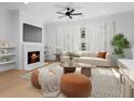 Bright living room boasts fireplace, hardwood floors, and neutral decor, creating a cozy and inviting atmosphere at 205 Mayfair Ct, Alpharetta, GA 30009