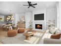 Bright, open living room featuring a fireplace, hardwood floors, and seamlessly flowing into the dining area at 205 Mayfair Ct, Alpharetta, GA 30009