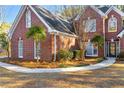 A beautiful brick home with a curved walkway leading to the front door at 3110 Haverhill Ne Cv, Conyers, GA 30012