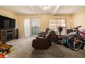 Living room showcasing neutral carpet, natural light, and furnishings at 6433 Stone Terrace Ter, Morrow, GA 30260