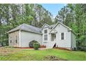 Inviting home exterior featuring lush lawn, mature trees, and meticulous landscaping at 377 Tapley Rd, Villa Rica, GA 30180