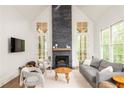 Inviting living room boasts soaring ceilings, natural light, modern fireplace and elegant finishes at 385 Anders N, Chattahoochee Hills, GA 30268