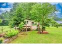 Backyard shed surrounded by lush landscaping and thriving foliage at 8140 Wood St Se, Covington, GA 30014