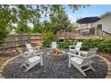 Backyard featuring a fire pit with Adirondack chairs, landscaping, and a deck at 1450 Walker Se St, Smyrna, GA 30080