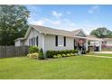 Well-maintained home exterior with manicured lawn and charming landscaping at 1450 Walker Se St, Smyrna, GA 30080