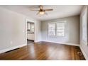 Well-lit living area showcasing hardwood flooring, neutral paint, and a view into the adjacent kitchen at 1450 Walker Se St, Smyrna, GA 30080
